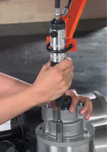 A Cleco balance arm countering the weight of a Cleco nutrunner to reduce operator fatigue and increase productivity.